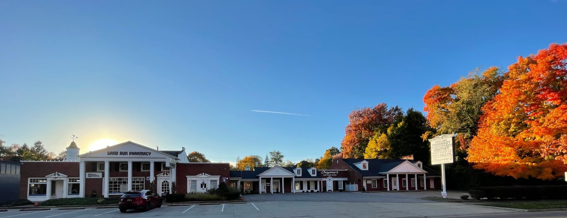 A row of buildings in an empty parking lot.